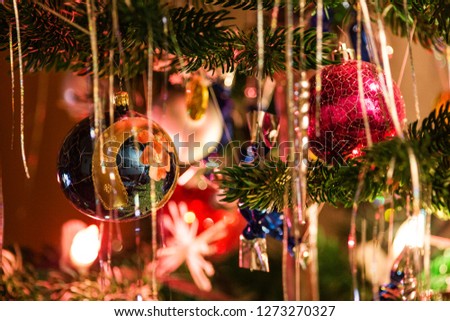 Still life picture with the details of Christmas tree, candles, balls and other Christmas decorations.