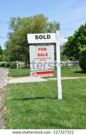 Sold Real Estate Sign on Front Yard Lawn