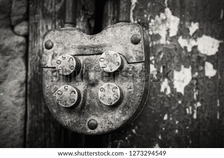 Old rural farm of peasants. On the barn hangs a lock with a code set on the numbers. Picture taken in Ukraine, Kiev region. Black and white image