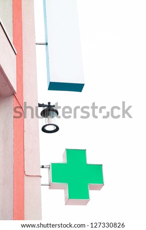 Green cross indicating the location of a pharmacy