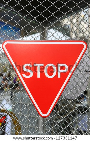Stop Sign against wire fence