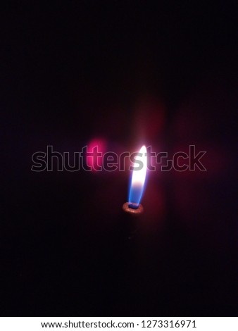 Flame emitting from lighter looks beautiful, glowing in dark fill with position energy