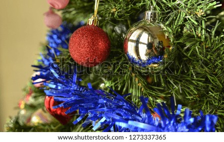 Detail of Christmas tree decoration, colored balls, shimmering ribbons. Christmas holiday concept.