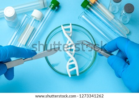 DNA helix research. Concept of genetic experiments on human biological code DNA. Medical instrument scalpel and forceps and test tubes
