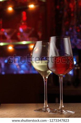 Two wineglasses in night bar