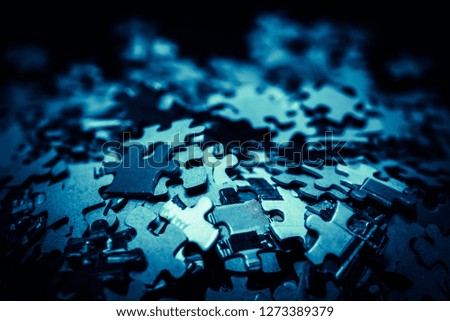 Close up piece of wooden jigsaw puzzle as a concept of business success in challenge completion with teamwork. Selective focus of pieces jigsaw puzzle background. 
