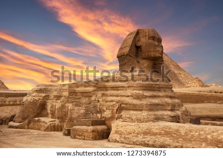 The Sphinx in Giza pyramid complex at sunset Royalty-Free Stock Photo #1273394875