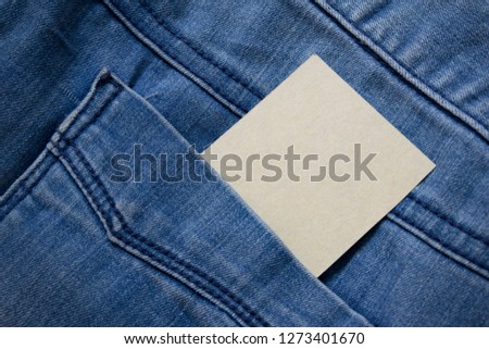 blank brown paper in back pocket of blue jeans with copyspace for sale text or business concept