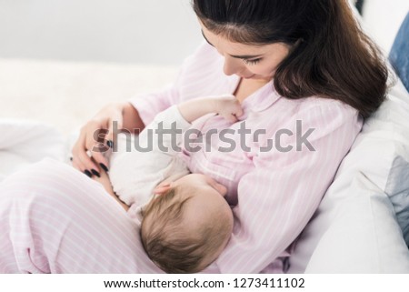 adorable baby sleeping on mothers hands
