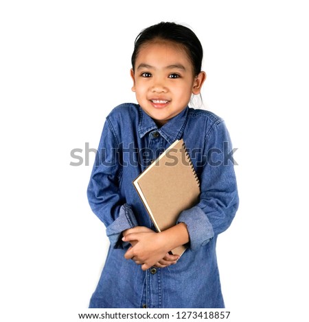 Asian little girl kindergarten holding a book isolated on white background , Education home school and back to school concept