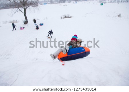 Sledding.Happy child on vacation. Winter fun and games.Little boy enjoying a sleigh ride.Children play outdoors in snow. Kids sled in the Alps mountains in winter