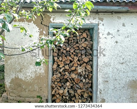 Funny photo of a firewood warehouse. So they put down the wood, that the hut cracked.
