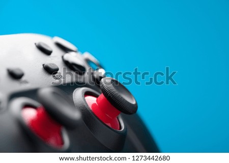 Gamepad video game controller retro toned on blue background