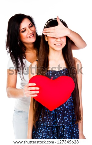 young and beautiful mother gives her daughter a heart