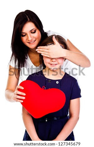 young and beautiful mother gives her daughter a heart