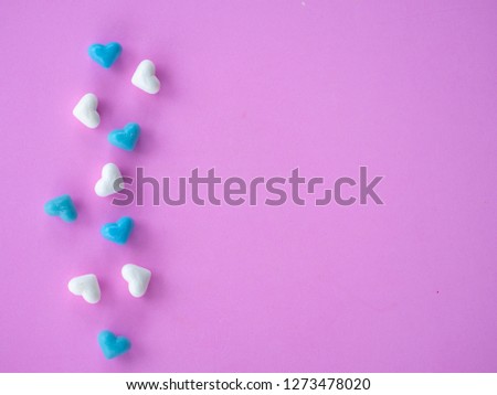 A lot of blue hearts shape and white hearts shape  put on pink pastel background have free or copy space for insert text, image using for valentine ‘s day signs and lovely sweet concept