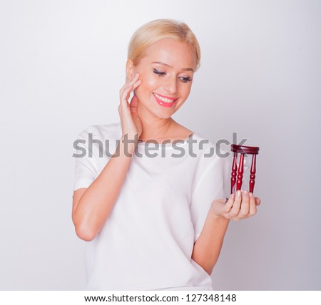 the girl the beautiful blonde in hands hourglasses