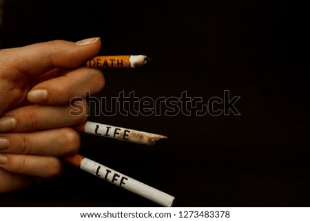 Three cigarettes in hand. The inscription on cigarettes life and death. World No Tobacco Day. Stop smoking. stop cigarettes and nicotine