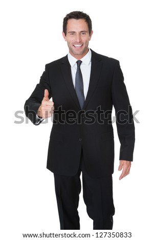 Portrait of happy middle aged businessman showing thumbs up sign. Isolated on white