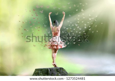 Woman is standing on a tree trunk with butterflies
