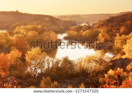 Autumn sunrise on the banks of the river, beautiful fall season landscape