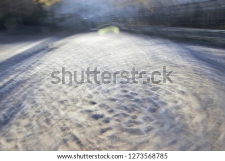 Tribute to Monet and Ernst Hass, impressionist photograph, photographic sweeps at low shutter speed, feeling of movement, of cold,  photographic sweeps of footprints in the sand with frost,