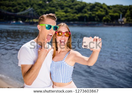 Show sign tongue crazy metal fan concept. Closeup photo picture portrait of cheerful mad excited ecstatic cool style funky funny stylish hipsters millennials take make selfie on gadget