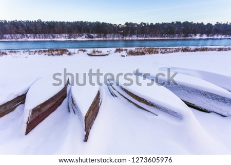 Boats covered in thick snow at winter