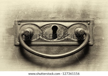 Old drawer handle in sepia tone