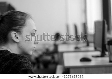the girl works at the computer in the classroom