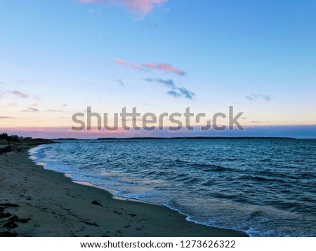 The beautiful sunset shining on the surface of sea on hyannis port beach in winter in barnstable hyannis Massachusetts United States.