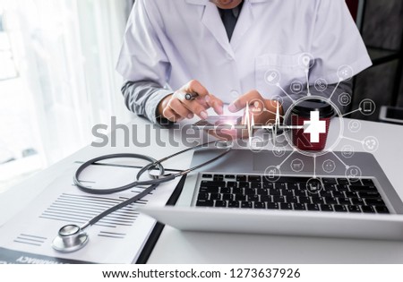 Medicine doctor hand working with modern digital tablet computer and smartphone interface as medical network concept.