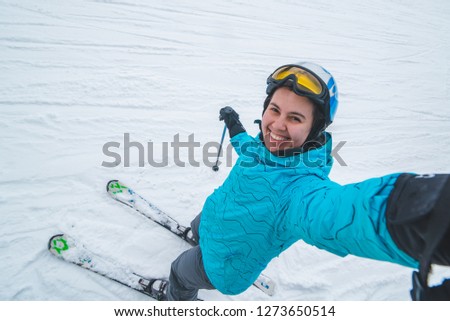 young pretty woman making selfie while skiing. sport winter activity