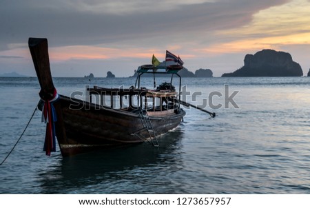 Sunset sky and long tail traditional boat  in Phra Nang Beach Cave, Railay, with limestone islands in the background, Krabi, Thailand, Southeast Asia, Asia
