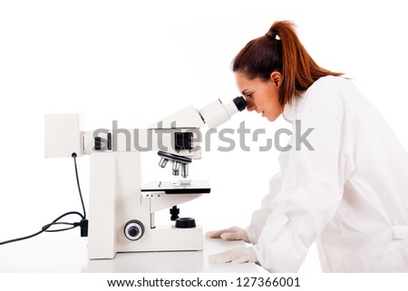 Female researcher looking through microscope, isolated on white
