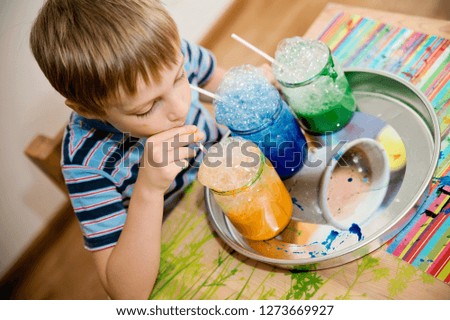 The child blows colored soap bubbles