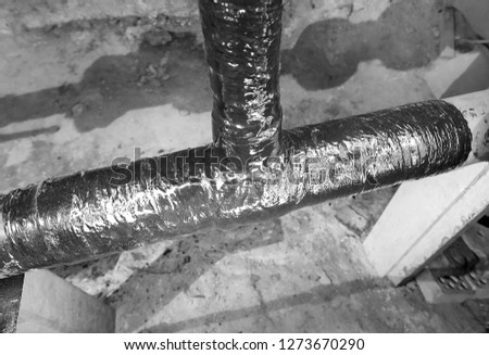 Basement apartment house. Water supply pipe. Completed repair tee. Picture taken in Ukraine. Kiev region. Horizontal frame. Black and white image