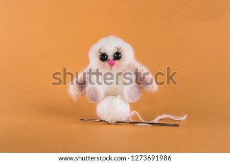 bunny knitted toy on a orange background