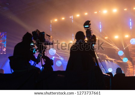 Silhouette of a group of cameramen broadcasting an event.
