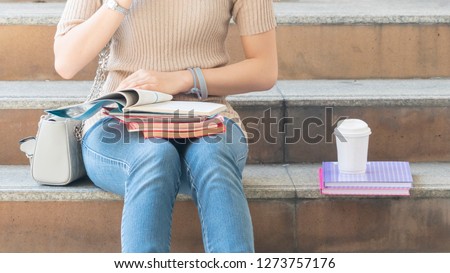 student teen girl with education book and coffee cup sit on stair pedestrian
