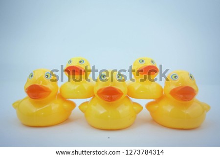 Arrangement of yellow rubber duck on white background