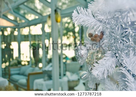White Christmas tree in the glass room
