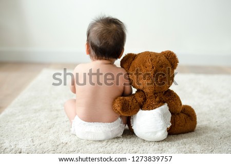 Back of a baby with a teddy bear Royalty-Free Stock Photo #1273839757