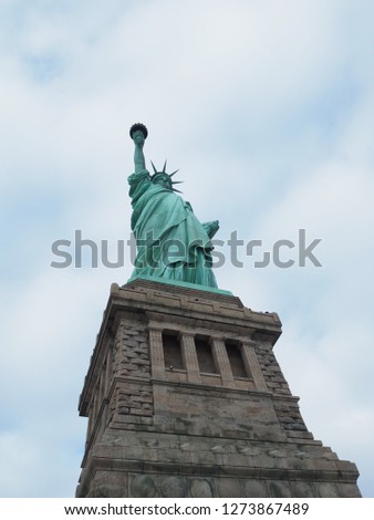 Statue of Liberty on light blue sky, landmark in New York City, USA.