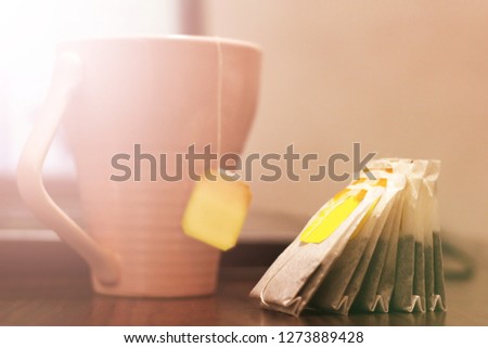 Tea bags and pink mug, toned image