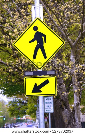 Yellow cross walk sign with arrow 