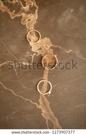 Forever together wedding heart rings on gold marble table, symbolize love and staying forever together, macro