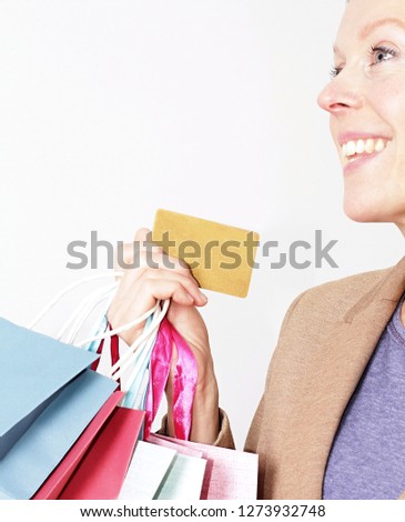 woman enjoying shopping with a credit card with people stock photo