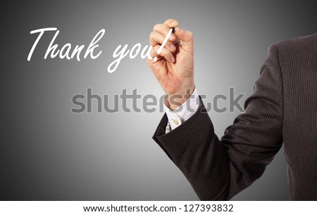 businessman write 'thank you' on glass