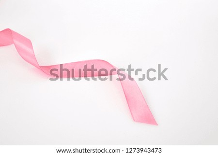 Curled pink ribbon on white background, Empty space for design